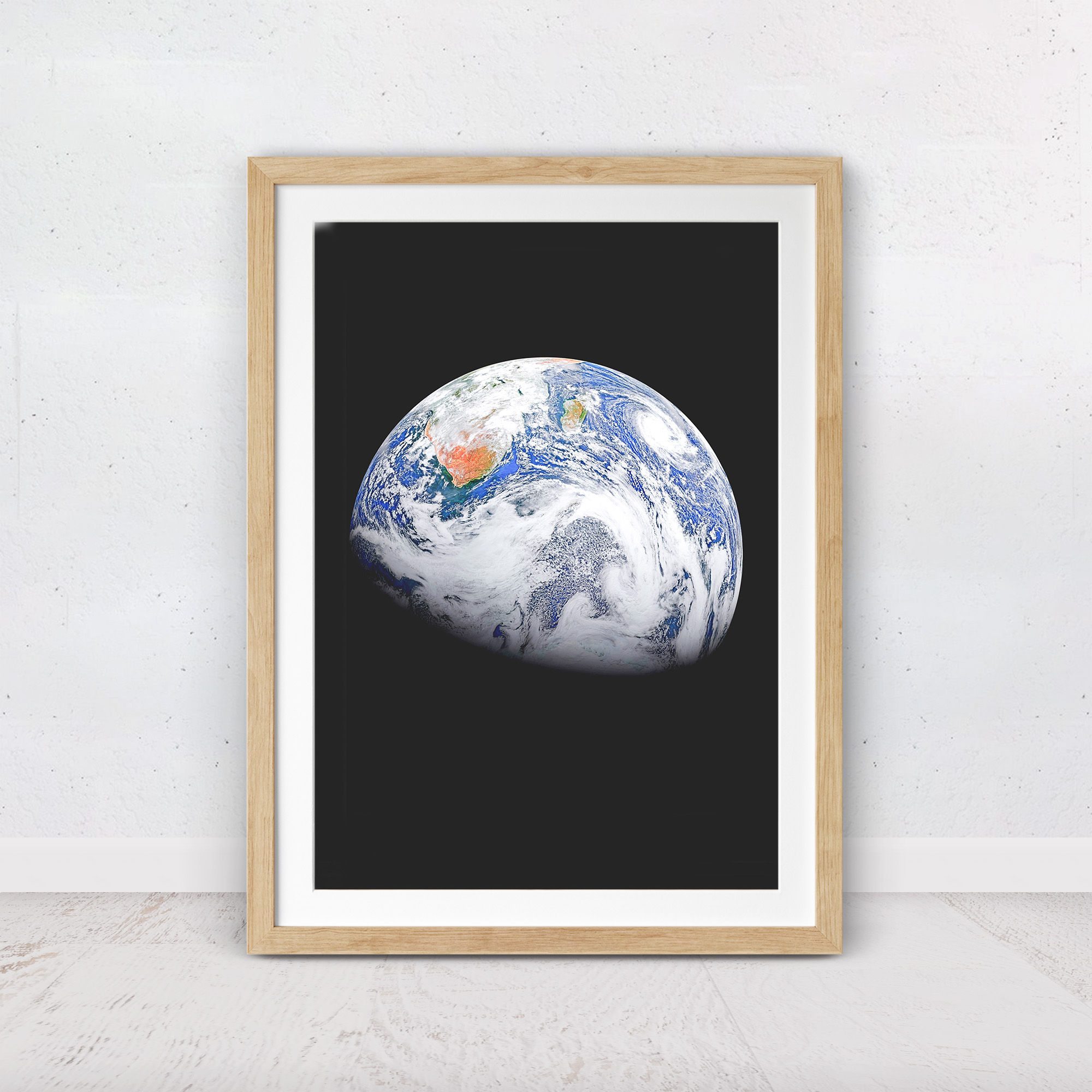 Space wall art featuring planet Earth with swirling white clouds