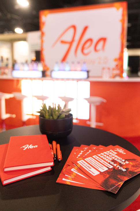 able displaying promotional materials and brochures within the Alea exhibition stand.