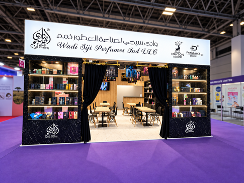 Front view of the Wadi Siji Perfumes exhibition stand at Beauty Istanbul, featuring illuminated branding, perfume displays and dark marble-look finishes.
