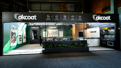 Wide-angle exterior view of the Akcoat booth at Zuchex 2025, featuring branded displays, modern lighting, and extensive product showcases.