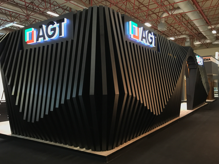 Side view of AGT exhibition stand with a flowing, ribbed black exterior design.