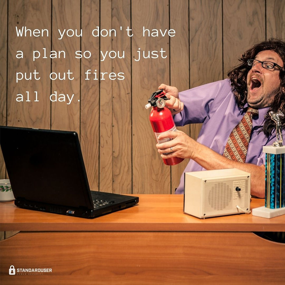 Man with shocked face aiming a fire extinguisher at a laptop computer.