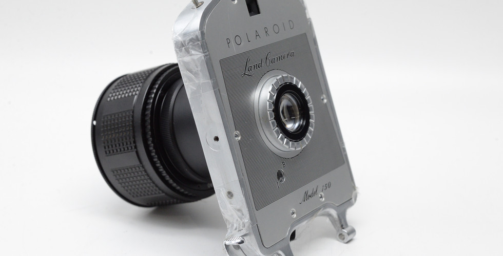 Side view of a Polaroid Land Camera Model 150 Lens 130mm f/8.8