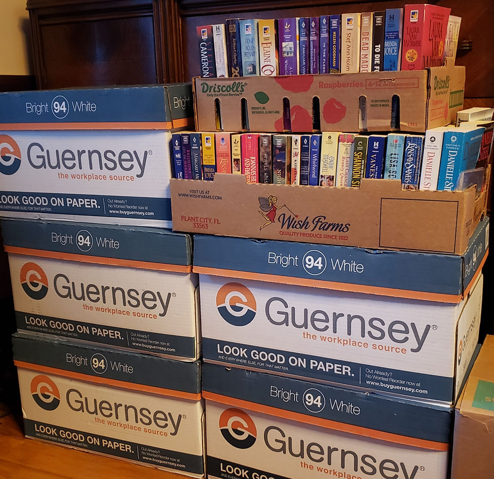 Two stacks of boxes containing a variety of books.