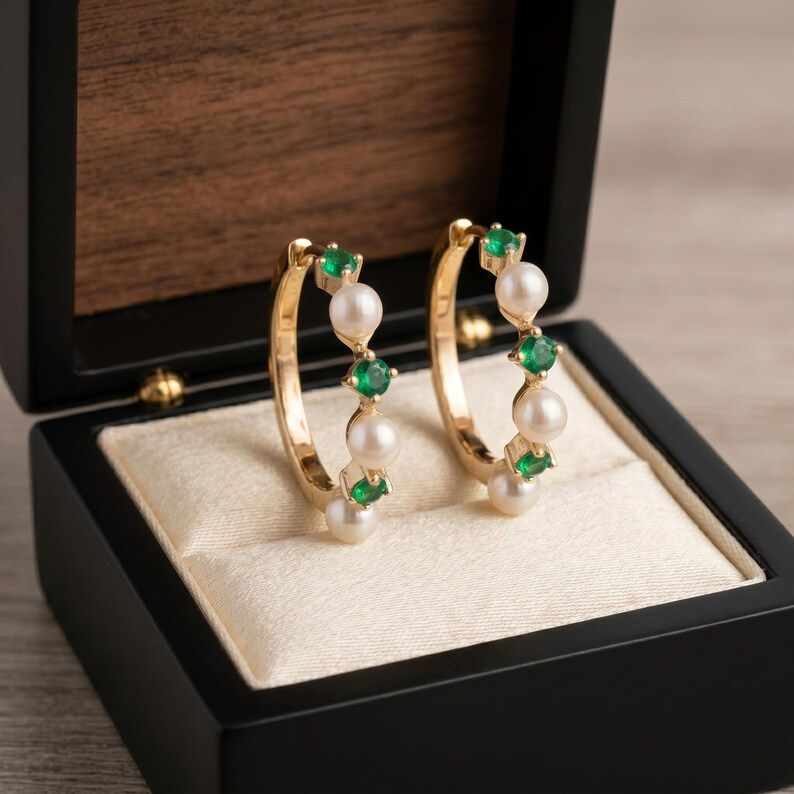 Thumbnail: Emerald & Pearl Huggie Hoop Earrings In Solid 14K Yellow Gold Anniversary Gift