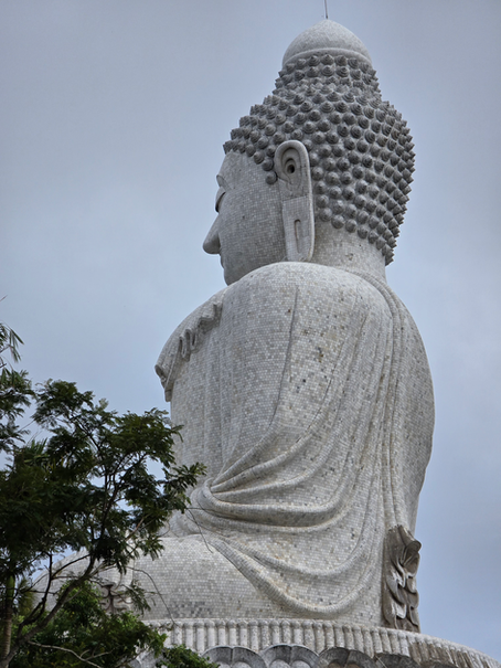 Buddha statue in Thailand, radiating stillness and compassion—captured during a journey of intuitive healing, where presence became purpose beyond the self.