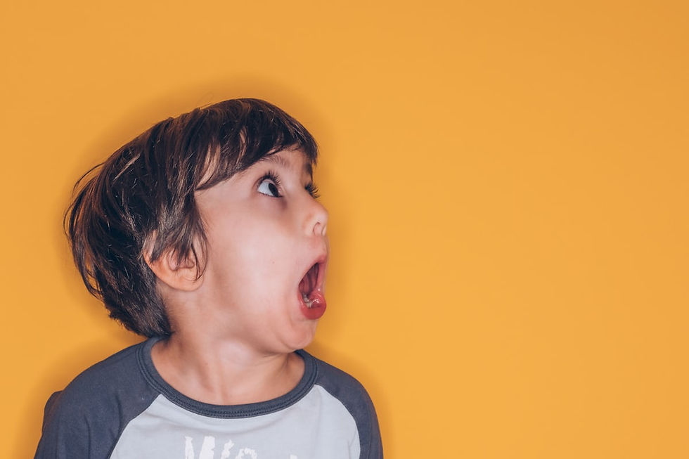 A scared kid on a yellow wall