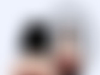 A woman with devil horns looking at herself in a mirror and in the mirror she has a halo