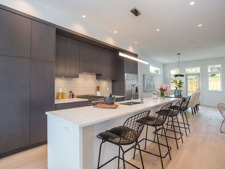 Kitchen with custom black cabinetry and white countertops.