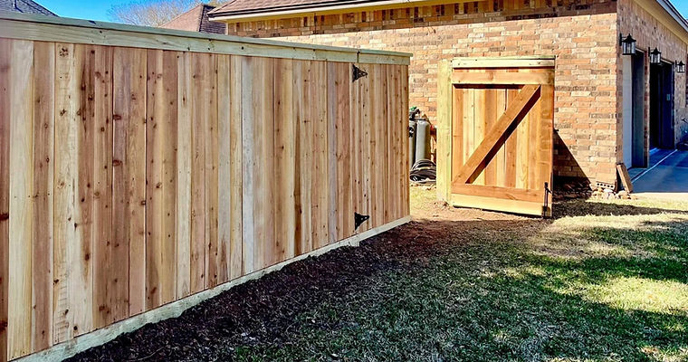 Exterior of cedar wood privacy fence with cap and trim. 