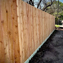 Residential exterior cedar fence with rot board. 