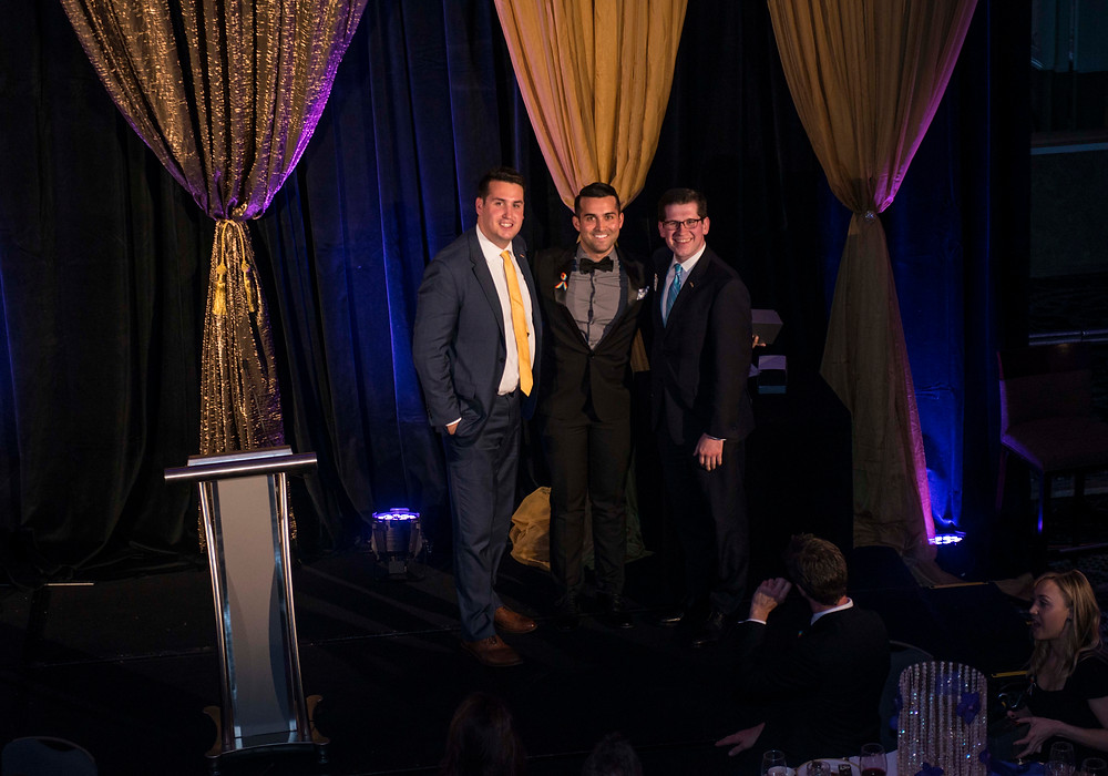 Orlando chapter chairperson, Derek Wood (middle), accepts this year's Member of the Year award.
