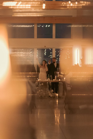 bride and groom framed by candlelight