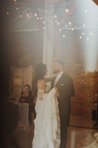 wedding couples first wedding dance through window reflection