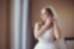 Bride Ellie putting on earrings in Budapest Hungary