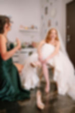Ellie putting on her shoes for wedding photography Budapest Hungary