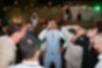 Groom and guests take shots at a Budapest wedding party.