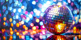 A shiny mirrored ball with a twinkling out of focus backgroun