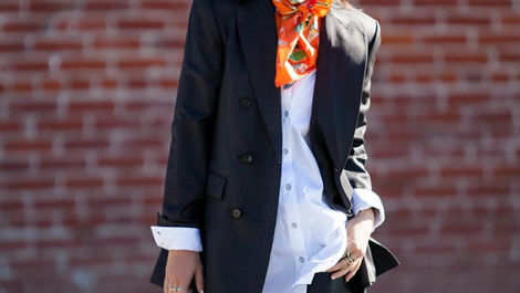 Orange silk scarf styled with black blazer and whtie shirt with dark jeans