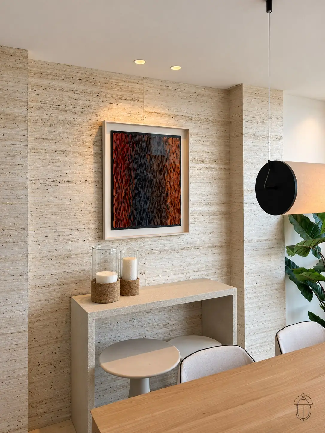 Stone console and artwork against a textured wall