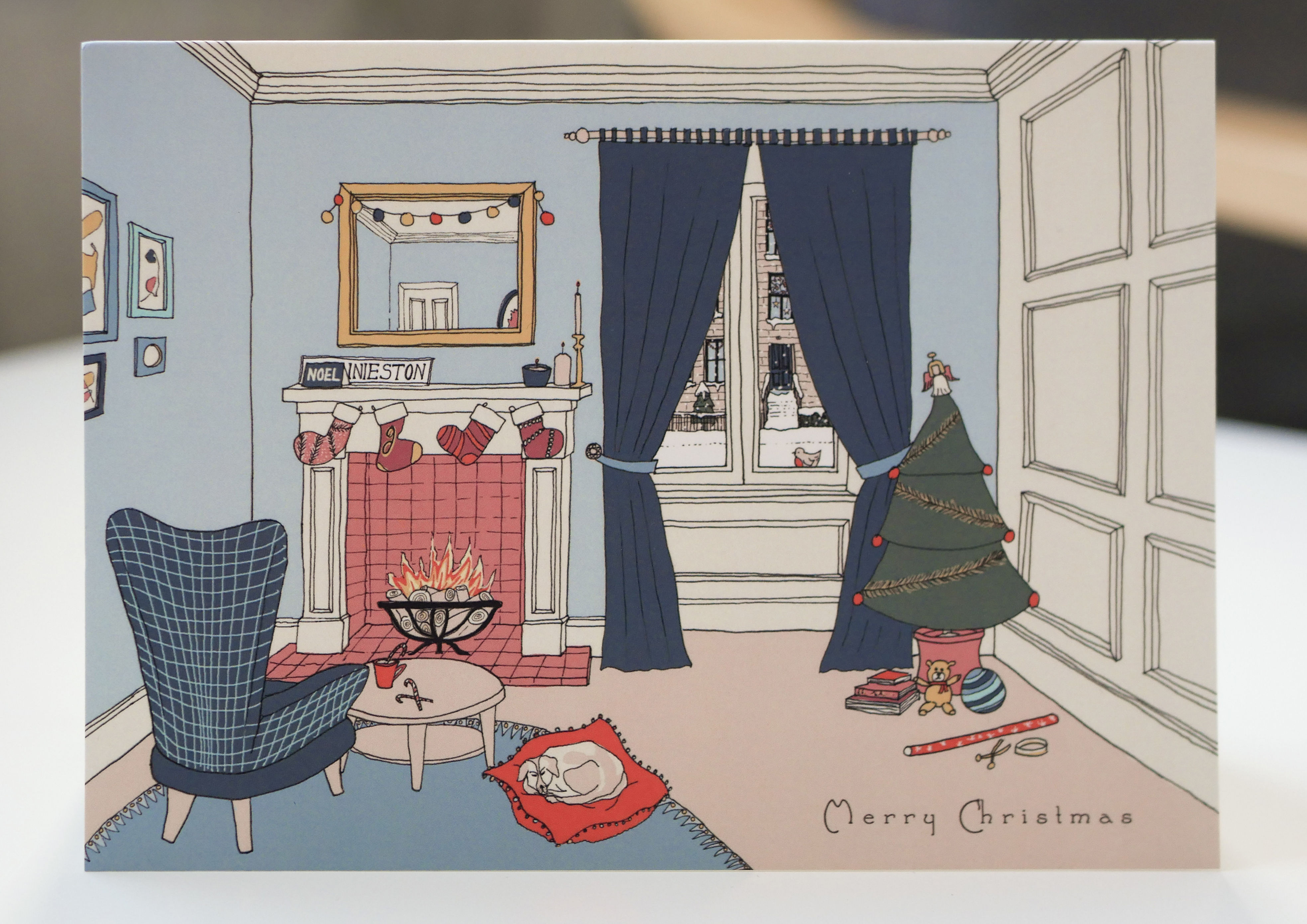 christmas card showing cosy living room in blue