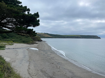 View over empty Pendower Beach