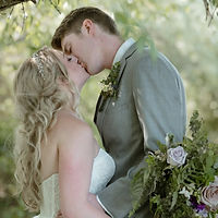 bride and groom kissing in the forest