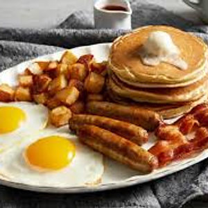Family Breakfasts Two pancakes served with eggs, bacon, sausage, ham, and home fries.