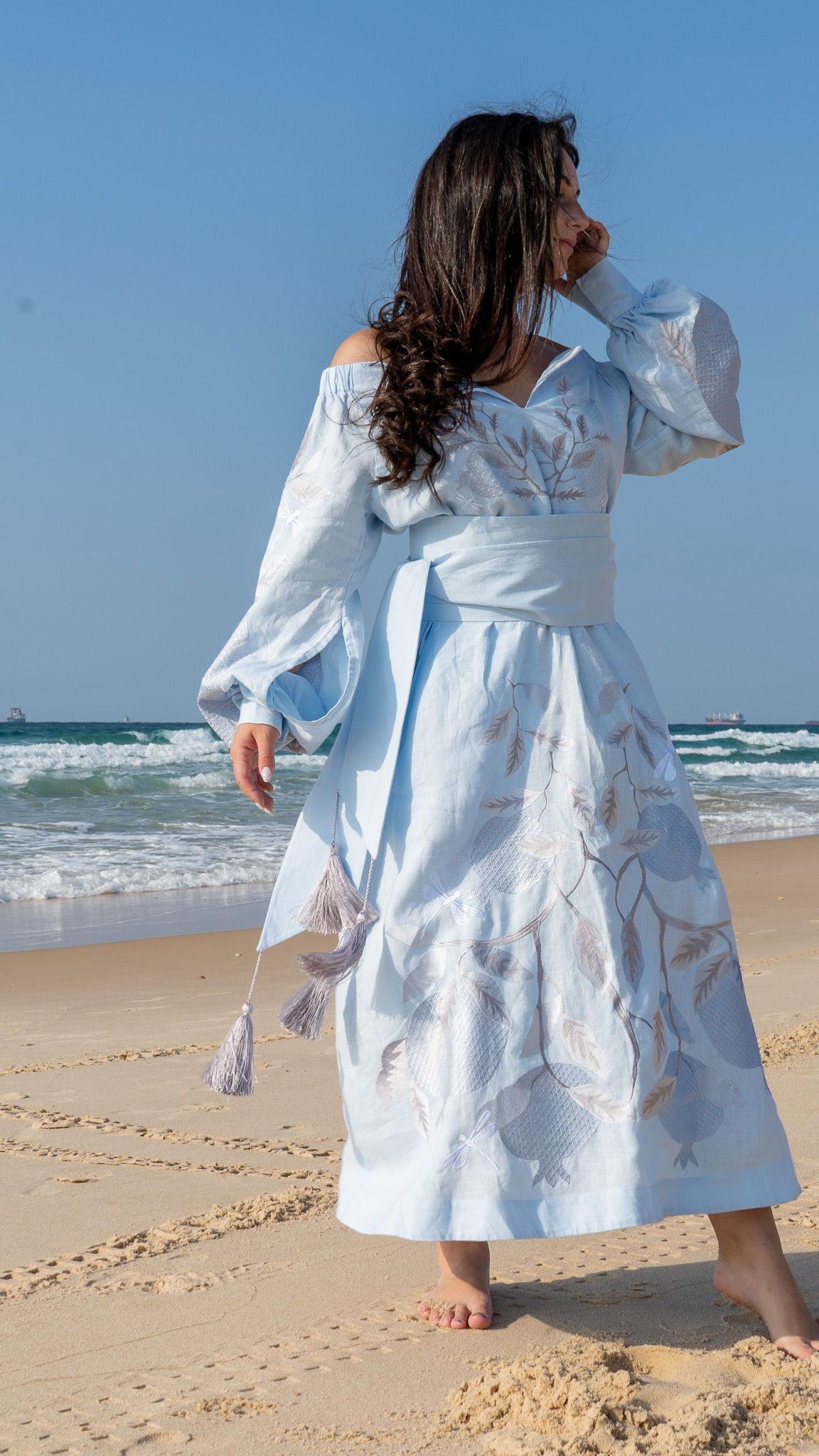 Light blue maxi dress with openings in the sleeves. Light blue maxi dress