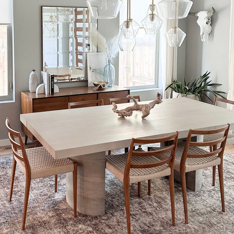 coastal and midcentury dining room with light wood table and neutral rug