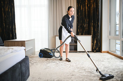 young-housekeeper-cleaning-carpet-with-vacuum-clea-2025-03-15-20-47-51-utc (1).jpg