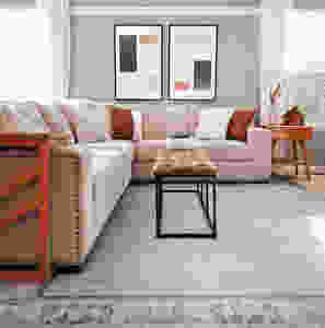 large sectional with blue rug and wall art