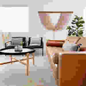 leather couch with wall art and black coffee table