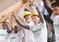 Volunteers Lifting Construction Frame