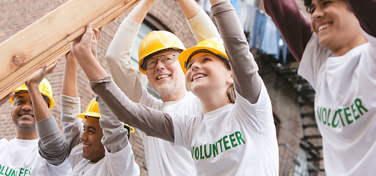 Volunteers Lifting Construction Frame
