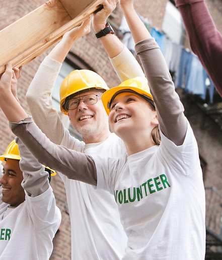 Volunteers Lifting Construction Frame