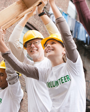Volunteers Lifting Construction Frame