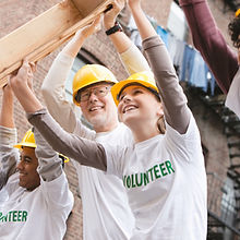 Volunteers Lifting Construction Frame