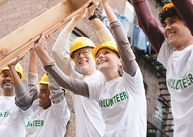 Volunteers Lifting Construction Frame