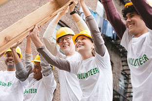 Volunteers Lifting Construction Frame