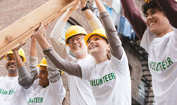 Volunteers Lifting Construction Frame