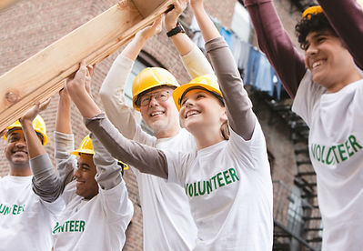 Volunteers Lifting Construction Frame