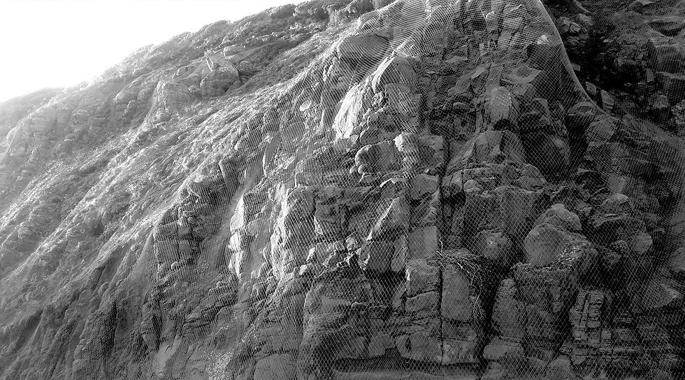 rockfall mesh drapes protecting infrastructure
