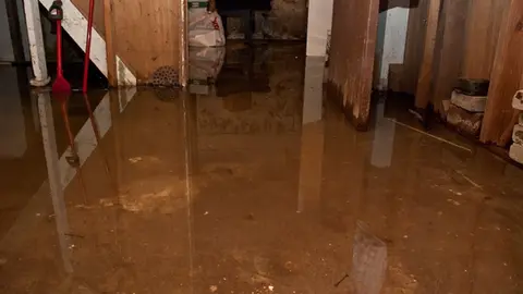 Basement flooded with standing water and damage visible