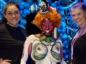 two artists posed with their body paint in wonderland theme