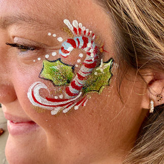 Holiday themed face paint candy cane
