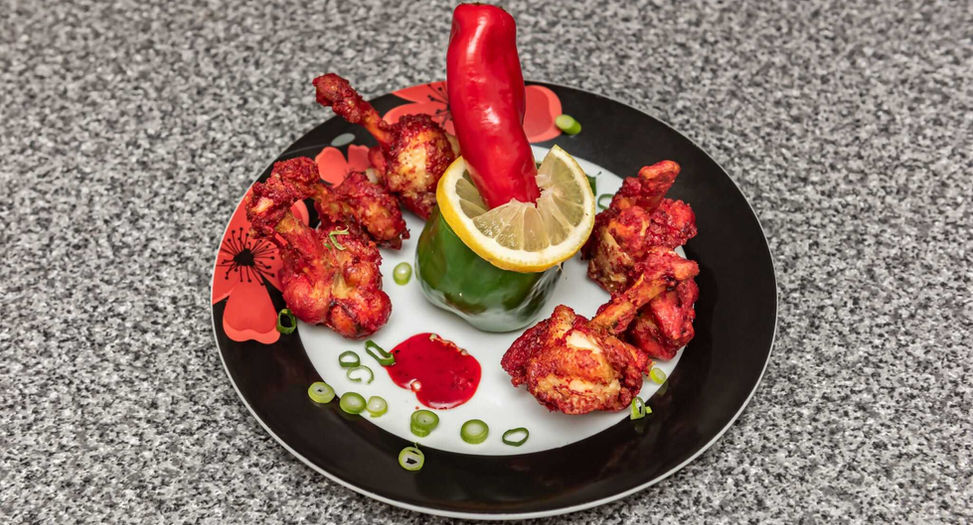 An Indian dish placed on a grey table