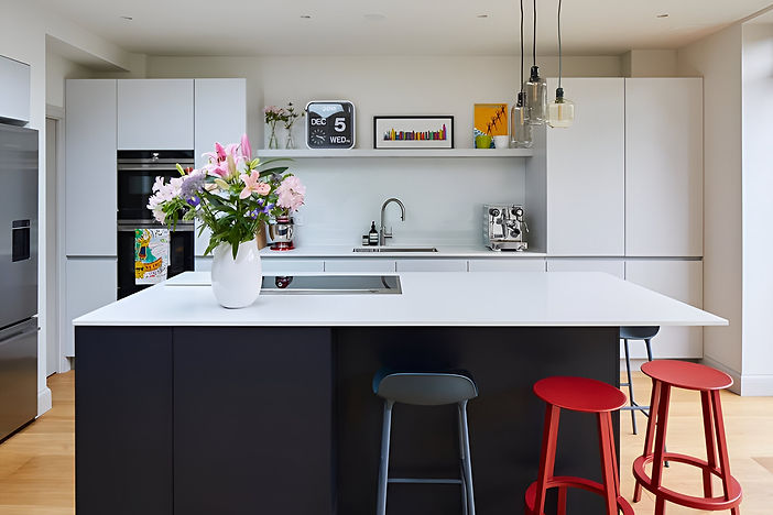 a large kitchen area with a white island