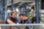 Two employees in our production hall working on a window with pleasure.