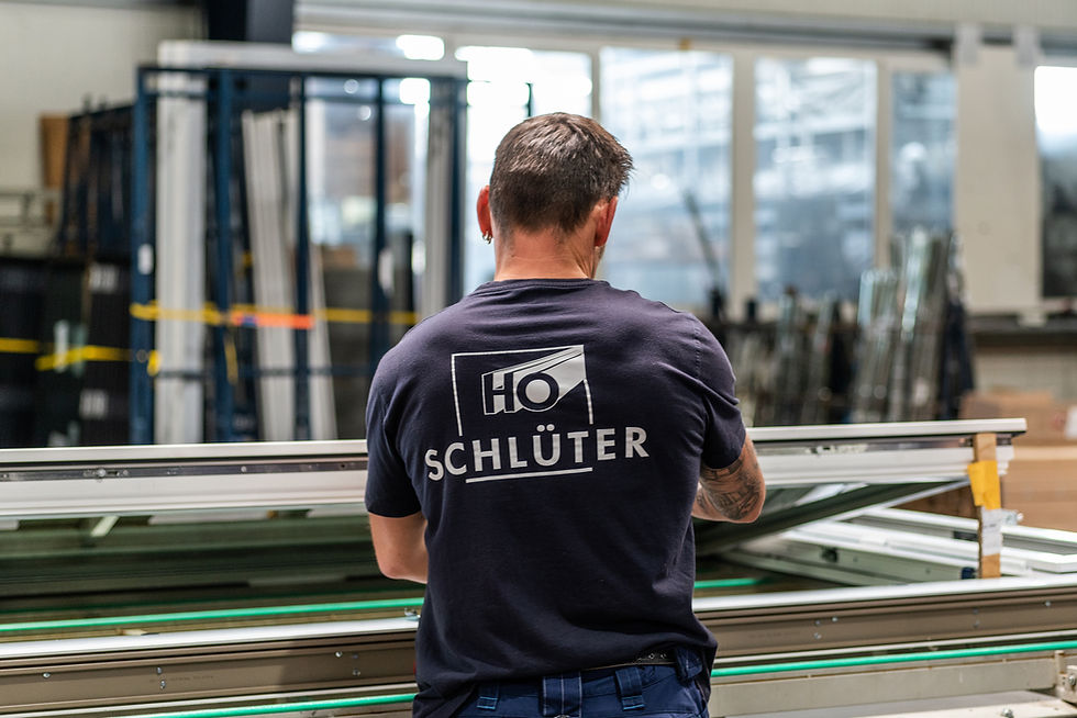 A photo of schlüters manufacturing facility showing an employee working on a window